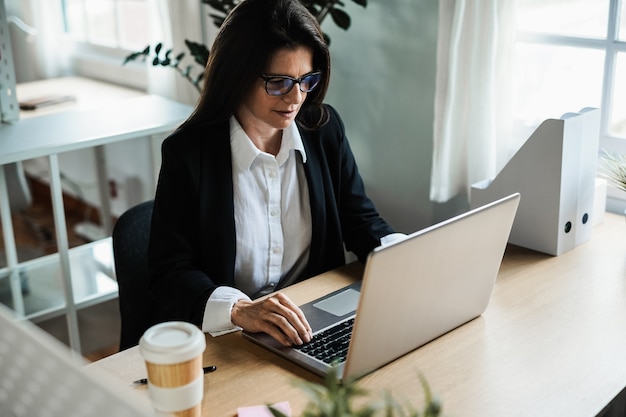 Premium Photo | Business mature woman working with laptop computer ...