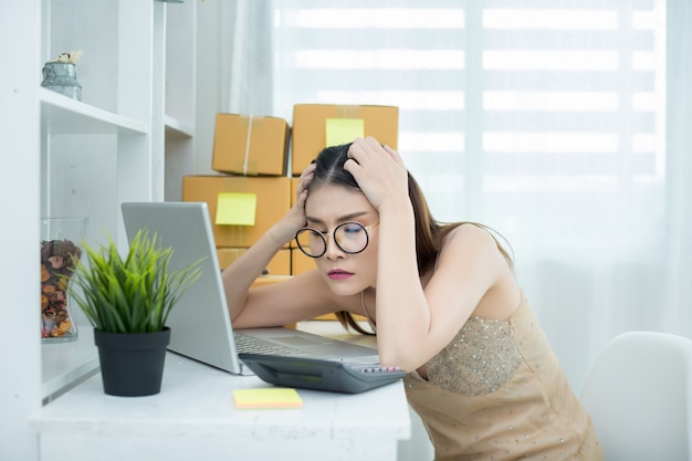 Business owner working at home office packaging Free Photo