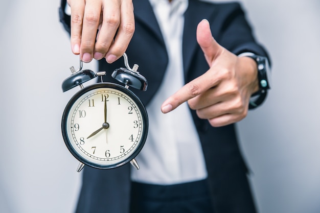 Premium Photo | Business people hand finger pointing at clock times at ...