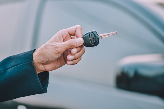 Premium Photo | Business people holding key at car