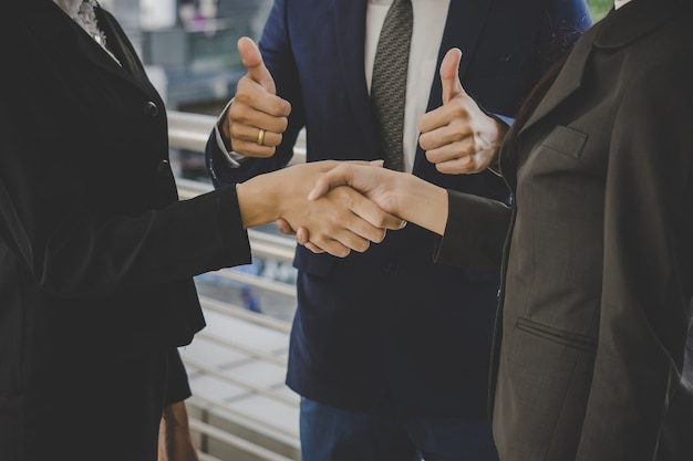 Business people shaking hands, finishing up meeting deals. business concept. Free Photo