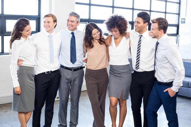 Premium Photo Business People Standing Together With Arms Around Each Other In Office 8537