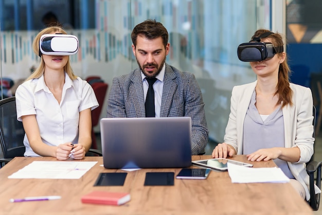 Premium Photo | Business people using virtual reality goggles during ...