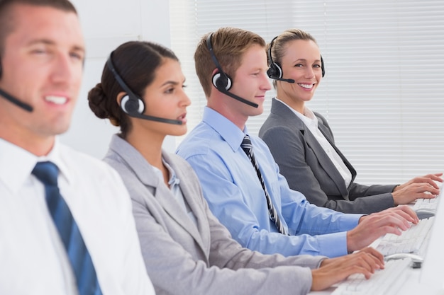 Premium Photo | Business team working on computers and wearing headsets