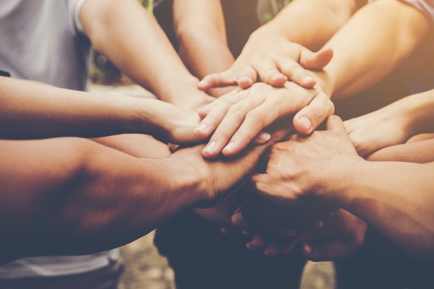 people joining hands together