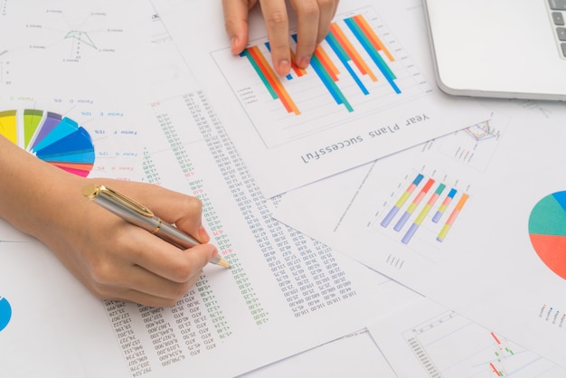 Business woman hand  with Financial charts  and laptop on the ta Free Photo