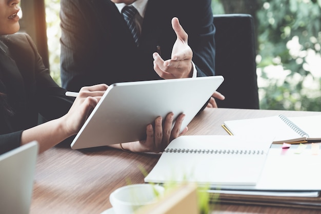 Business woman and lawyers discussing and using digital tablet  on wooden desk in office. law, legal services, advice, justice concept. Premium Photo