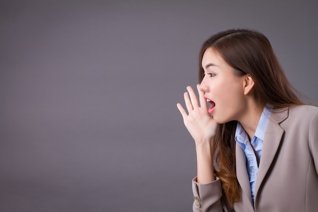 Premium Photo | Business woman shouting to one side