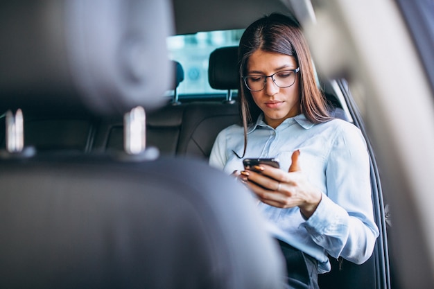 business-woman-sitting-car-using-phone_1