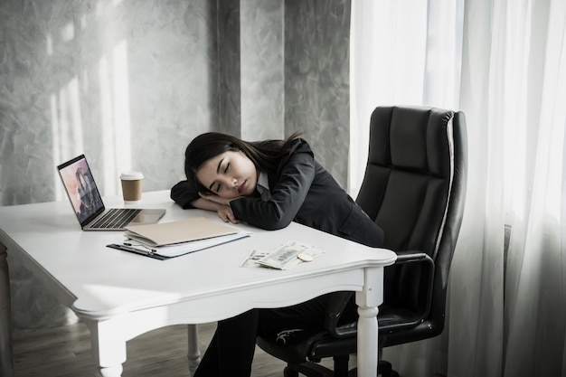 Business Woman Sleep On Desk Workplace After Tired Work Hard