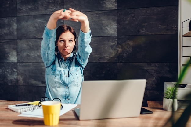 Premium Photo | Business woman stretching arms in the office