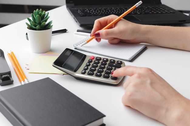 Premium Photo | Business woman working with financial data hand using  calculator