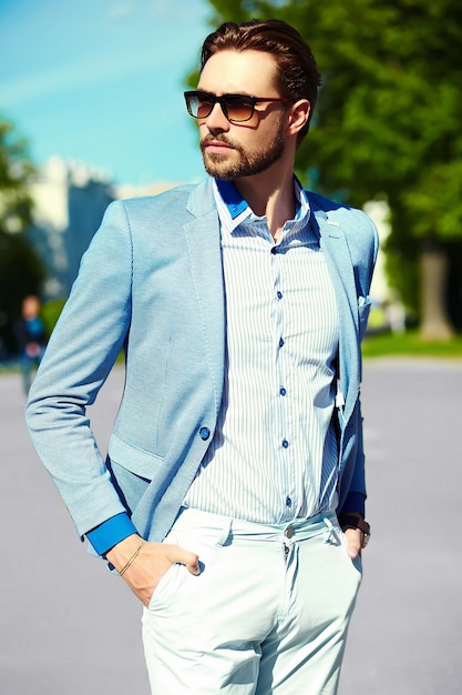 Free Photo | Businessman in blue suit wearing sunglasses in the street