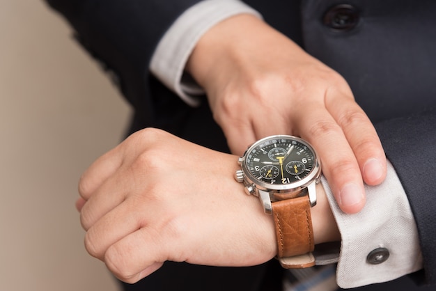 Businessman checking the time Free Photo