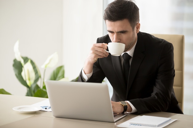 Free Photo Businessman Drinking Coffee When Working In Office