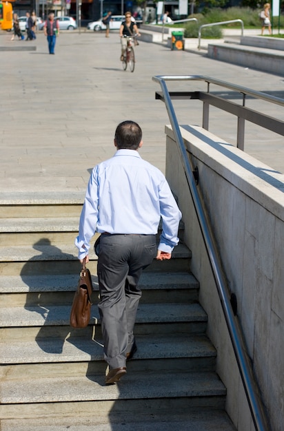 Premium Photo | Businessman go up the stairs