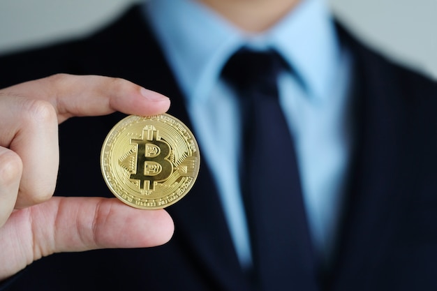 Premium Photo | Businessman hand holding bitcoins