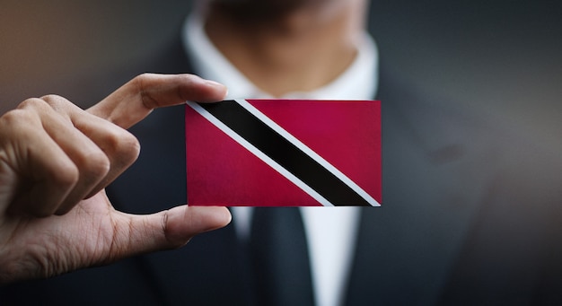 Businessman holding card of trinidad and tobago flag Premium Photo