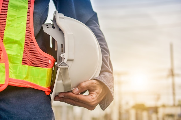 Premium Photo | Businessman holding hard hat building estate ...