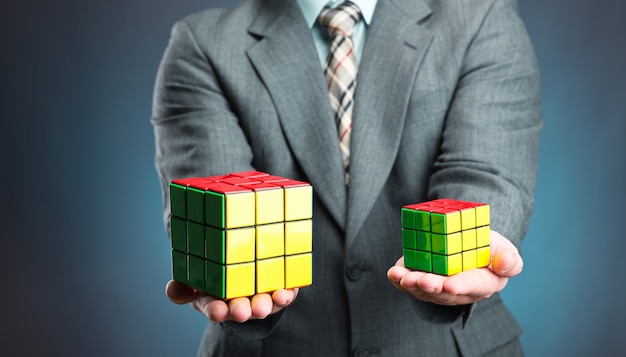 Premium Photo Businessman Holding Rubik Cube In His Hands Closeup