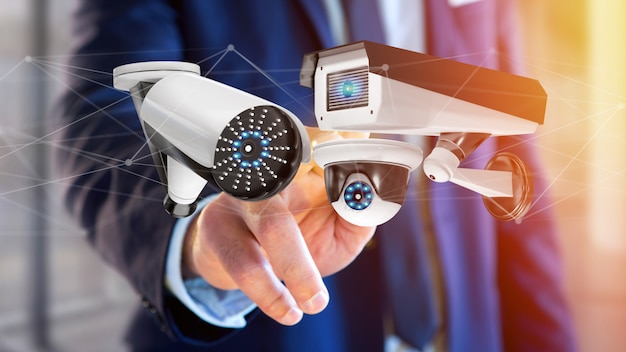 Businessman holding a security camera system and network connection - 3d rendering Premium Photo
