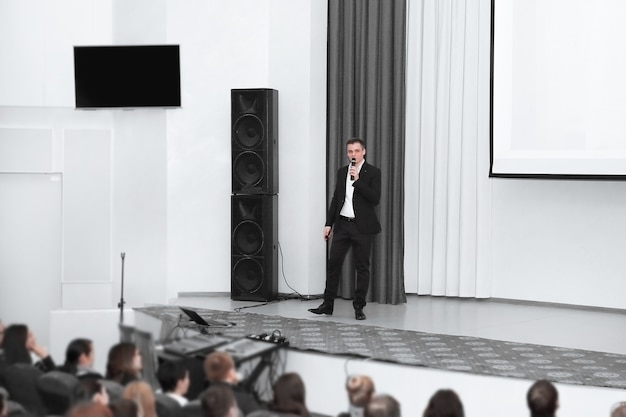 Premium Photo | Businessman man standing on stage during a press ...