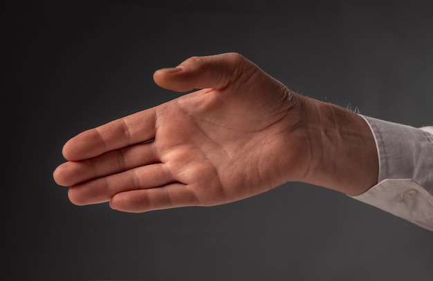 Premium Photo | Businessman outstretched his hand for handshake, side view.