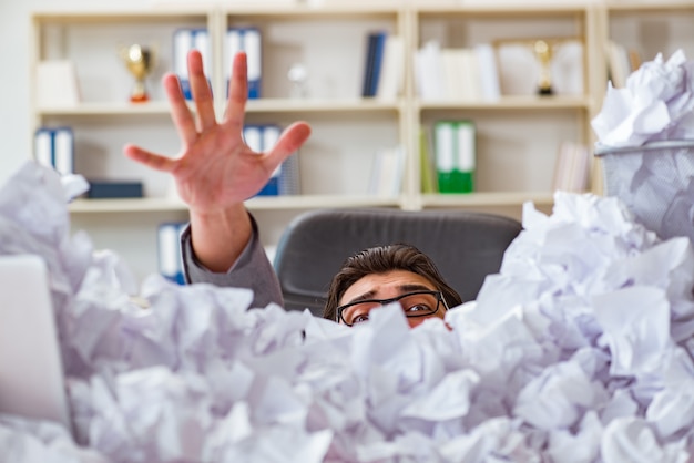 Businessman in paper recycling concept in office Premium Photo