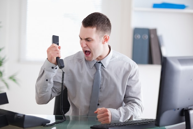 Premium Photo | Businessman shouting at the phone