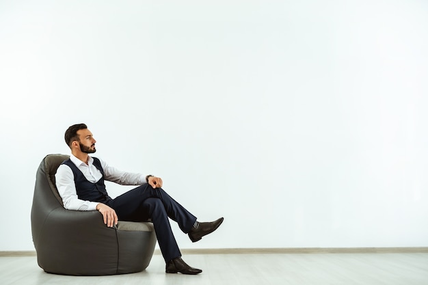 Premium Photo | The businessman sitting on a bag chair on the white ...