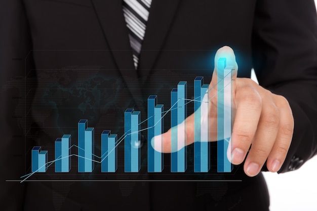 Businessman touching the tip of a bar chart Free Photo