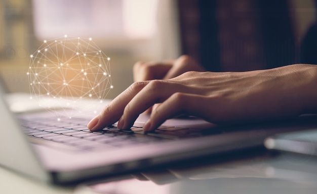 Businessman typing laptop keyboard and show sign technology icon. concept of future and trend internet for easy access to information. Premium Photo