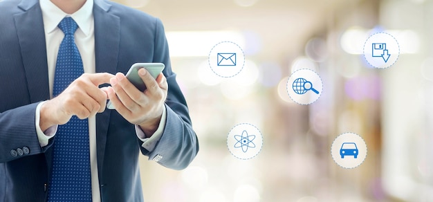 Businessman using smart phone with internet of things icon on blurred background, business and technology concept Premium Photo Businessman using smart phone with internet of things icon on blurred background, business and technology concept Premium Photo
