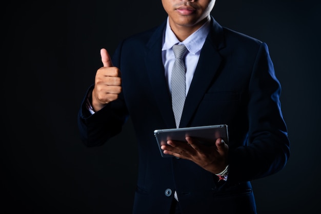 Businessman using tablet analyzing sales data and economic growth graph chart, technology Free Photo