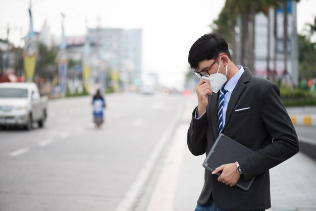 Businessman wearing protective face mask and cough, coronavirus and pm 2.5 fighting Premium Photo