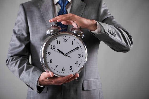 Premium Photo | Businessman with clock in business concept