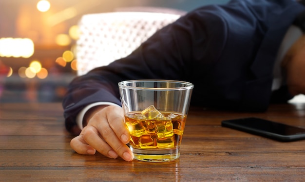 Premium Photo | Businessman with whiskey bourbon in hand, drunk ...