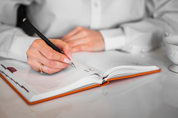 Free Photo | Businessman writing into notebook