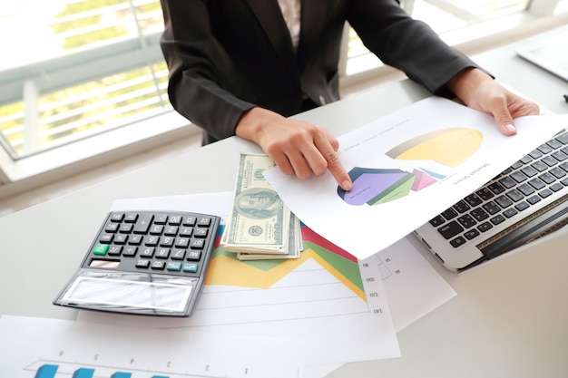 Businesswoman using computer, tablet and working with graph company summary report Premium Photo