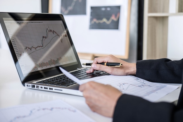 Businesswoman working with computer, laptop, discussing and analysis graph stock market trading Premium Photo