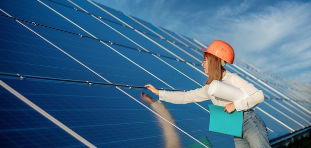 Businesswomen working on checking equipment at solar power plant with tablet checklist Premium Photo