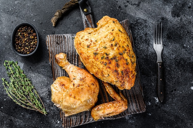 Premium Photo | Butchered grilled whole chicken. black background. top ...