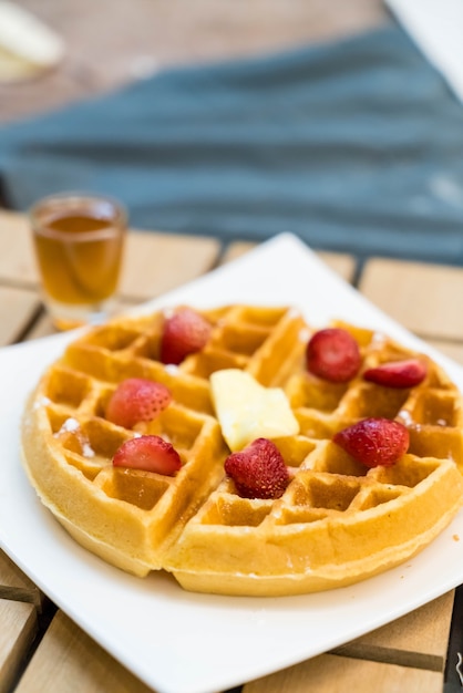 Free Photo | Butter waffle with honey and strawberry