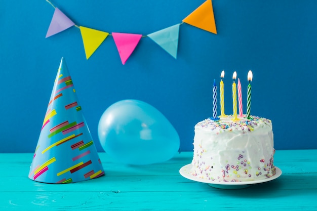 Free Photo | Cake with candles and party hat