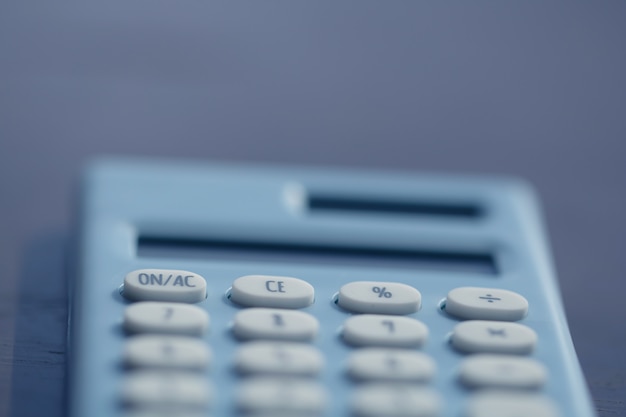 Premium Photo | Calculator and pen on book background