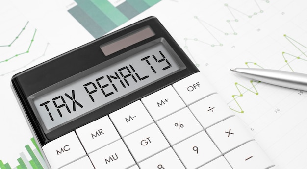 premium-photo-calculator-with-the-word-tax-penalty-on-display-with-chart