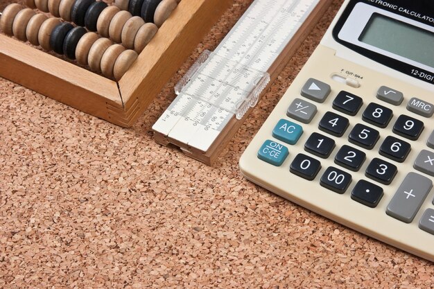 premium-photo-calculator-a-wooden-abacus-and-slide-rule-on-a-cork-board