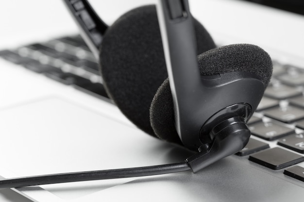 Call center support concept headset on keyboard computer laptop Premium Photo