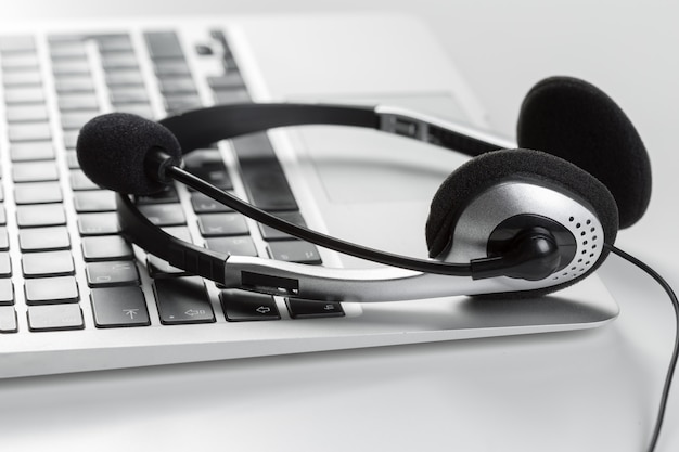 Call center support concept. headset on keyboard computer laptop Premium Photo