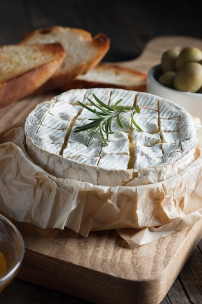 Premium Photo | Camembert and brie cheese on wooden with tomatoes ...